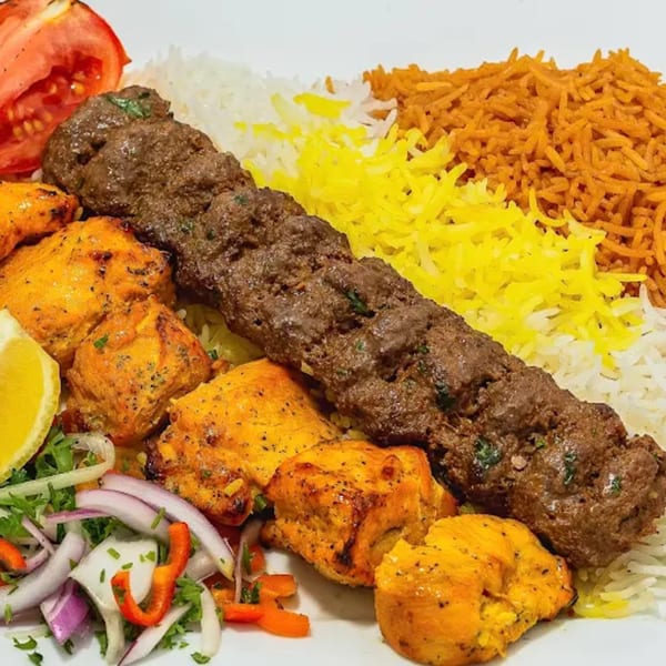 Grub Palace's Afghan platter with beef kofta, chicken tikka, white rice, saffron rice, and salad.